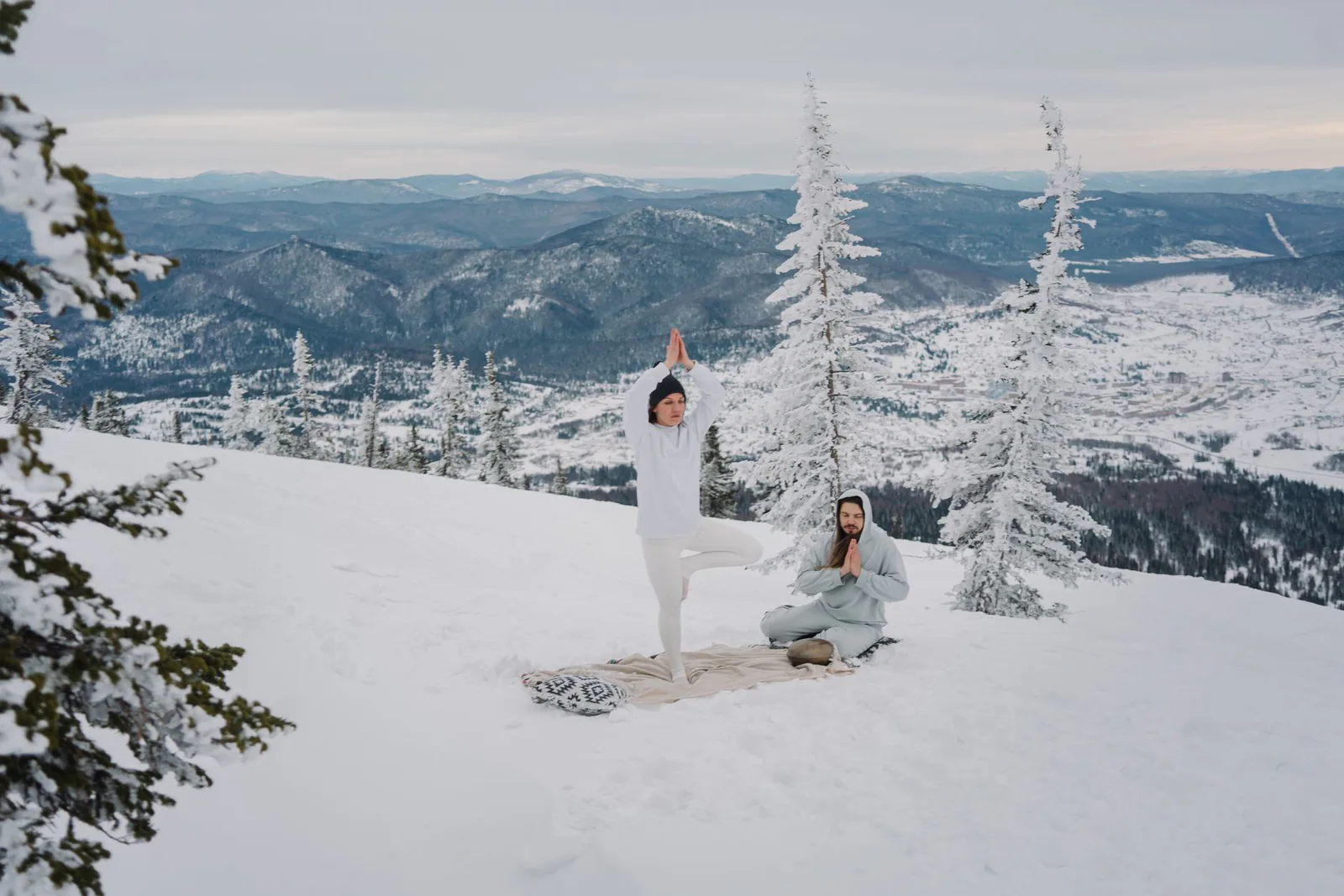 People practicing yoga and meditation in a serene mountain landscape